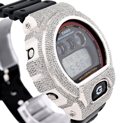 Digital watch with a heavily embellished silver case on a white background